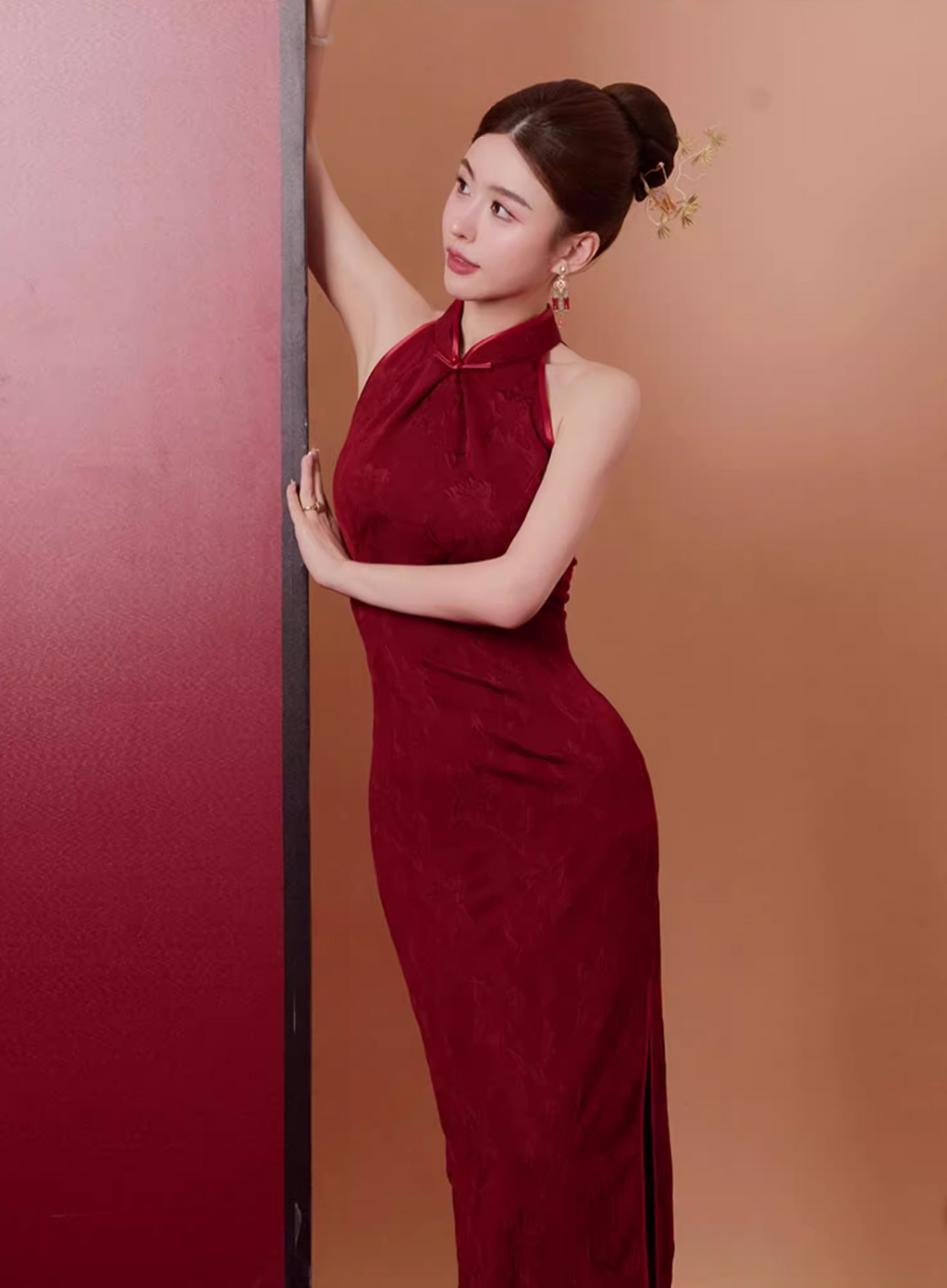 Woman in a red Qipao dress against 